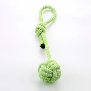 Durable green braided cotton rope ball dog toy for small and medium dogs teething needs.