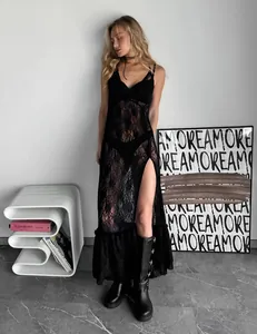 Detailed shot of black sheer lace maxi dress with V-neck and high side slit