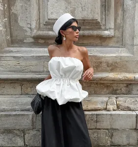 Elegant chic white strapless tube top with ruffled hem and waist-cinching detail for summer