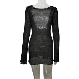 Detail of black sheer knitted beach cover-up mini dress featuring a hollow-out design.