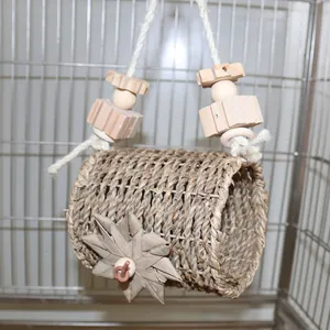 Detailed view of hand-woven straw bird nest tunnel with natural wood beads hanging