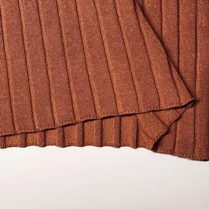 Macro detail of brown ribbed knit texture and hem on a slim fit sleeveless vest top