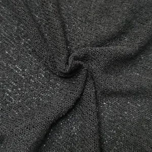 Detailed macro view of the black sheer knitted fabric texture on summer beach cover-up