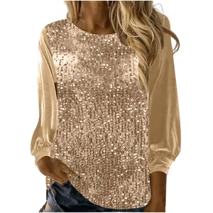 Detailaufnahme des goldenen Damen-Paillettenoberteils mit langen Ärmeln und Rundhals