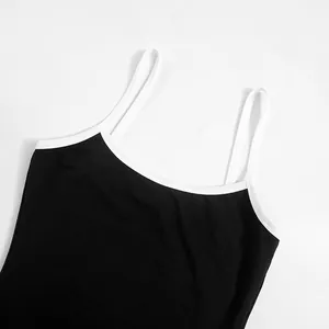 Gros plan d'un caraco noir avec une encolure contrastée blanche et fines bretelles