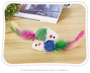 Close-up detail of plush cat toy mice with vibrant colorful feather tails on wood
