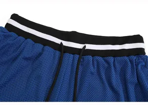 Close-up of blue mesh athletic shorts featuring a striped elastic waistband and drawstring