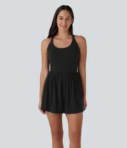 Detail view of a stylish black sleeveless romper featuring a flared pleated short hem.