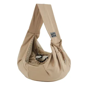 Breathable tan pet sling bag with mesh window and shoulder strap for cats and dogs