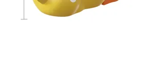 Close-up of yellow whale-shaped pet treat dispenser with size measurement guide line