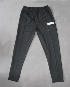 Men's black fitness sweatpants with tapered leg and elastic drawstring waist.