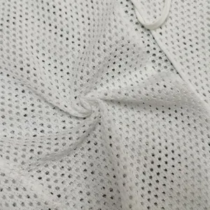 Macro view of white breathable mesh knit fabric texture of a cardigan
