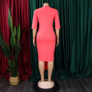 Detailed back view of a coral pink bodycon midi dress featuring 3/4 sleeves and a rear slit