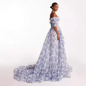 Detailed view of elegant off-shoulder floral organza evening gown with a long train.