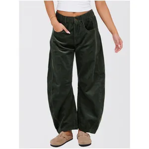 Detail of dark green corduroy wide-leg pants showing texture and high waist fit