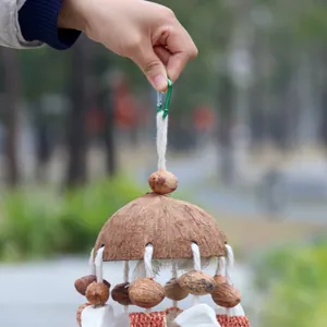 Parrot hanging toy featuring natural coconut shell, nuts, and chewing cuttlebone