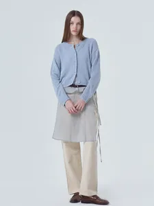 Full-body view of a stylish light blue round neck knit cardigan with button closure