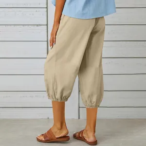 Rear view detail of loose khaki cotton linen cropped pants with gathered elastic cuffs