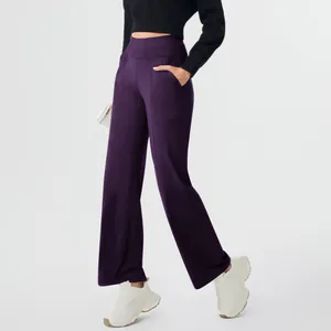 Professional detail view of purple high-waisted yoga pants with pockets and straight leg design