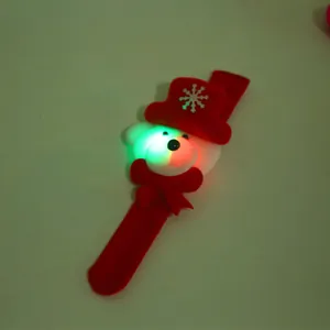 Close-up of a festive LED Christmas slap bracelet featuring a glowing white bear with red hat