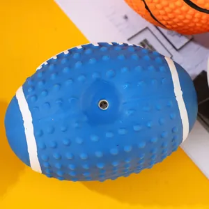 Close-up detail showing the textured surface and squeaker hole of a blue latex rugby dog toy