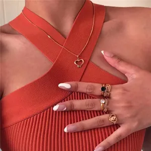 Detailed view of an orange cross halter neck knit crop top featuring stylish ribbed texture