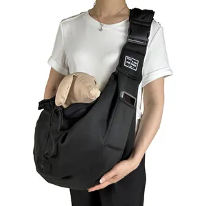 Detail of black breathable pet sling carrier bag with adjustable shoulder strap