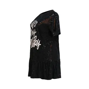 Detail view of a black sequined party dress featuring an It's my Birthday print
