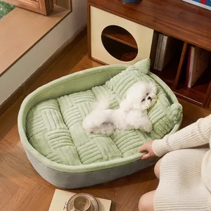 Soft plush green oval dog bed for small dogs and cats in a warm, cozy home setting