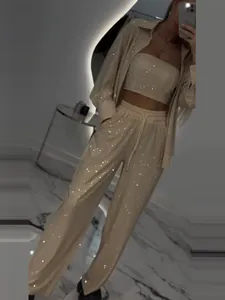 Elegant beige 3-piece sequined set featuring long sleeve shirt, tube top and wide pants.