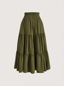 Detailed front view of tiered olive green midi skirt featuring a smocked elastic high waist