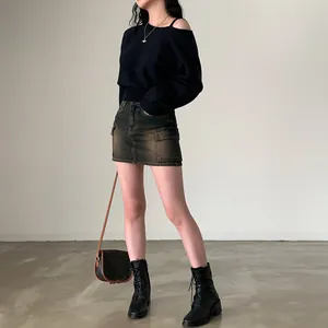 Vista dettagliata di un maglione in maglia chic con spalle scoperte e vestibilità morbida