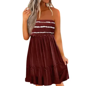 Detailed view of smocked strapless bodice and ruffled tiered skirt on red dress