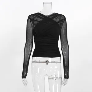 Close-up detail of black mesh long-sleeve top with elegant cross V-neck design