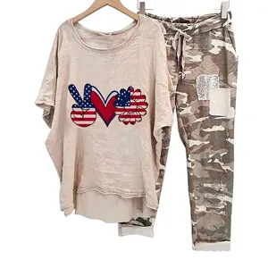 Detail view of women's two-piece set featuring camouflage pants and a printed T-shirt.