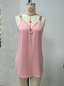Close-up detail of a pink V-neck camisole featuring metallic chain straps and a front zipper.