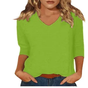 Close-up detail of women's lime green V-neck casual three-quarter sleeve T-shirt top