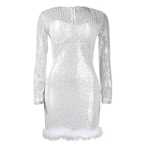 Detailed close-up of a glamorous silver sequined bodycon dress with feather trim