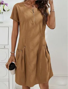 Detailed view of women's brown cotton linen dress with zipper neck and side pockets