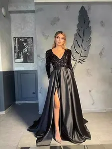 Elegant black sequined evening gown with deep V-neck, long sleeves and a high slit satin skirt