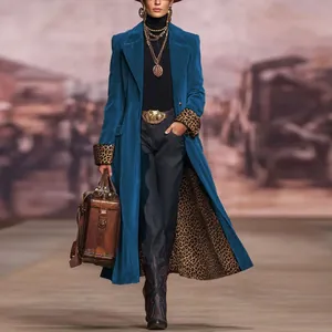Full-length shot of a luxury blue velvet coat with striking leopard print sleeve details.