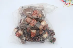 Bulk natural parrot toy components including pine cones and corn cobs in a clear bag