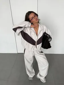 Stylish women's beige and brown color block two-piece tracksuit set with zip-up jacket.