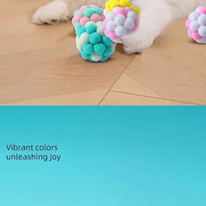 Detail of colorful macaron plush cat toy balls on a wooden floor for feline fun