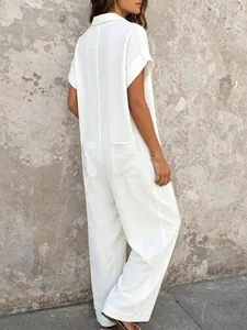 Back view of a white loose short-sleeve jumpsuit with shirt collar and large pockets