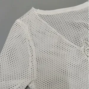 Detailed view of the white mesh knit fabric on a long-sleeve cardigan with bow tie
