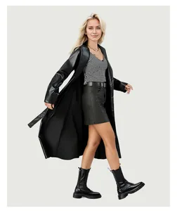 Detail shot of a long black faux leather trench coat with tie-belt for women.