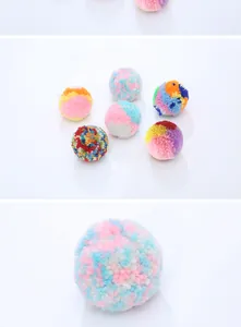 Macro detail of soft colorful yarn pom-pom ball cat toy with dense plush texture