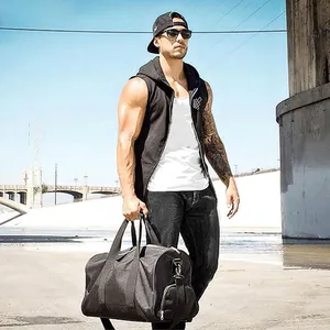 Muscle men's sleeveless hooded gym vest shown in a lifestyle outdoor setting.