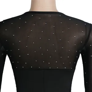 Detailed view showing the fine mesh texture and sparkling rhinestones on a black dress